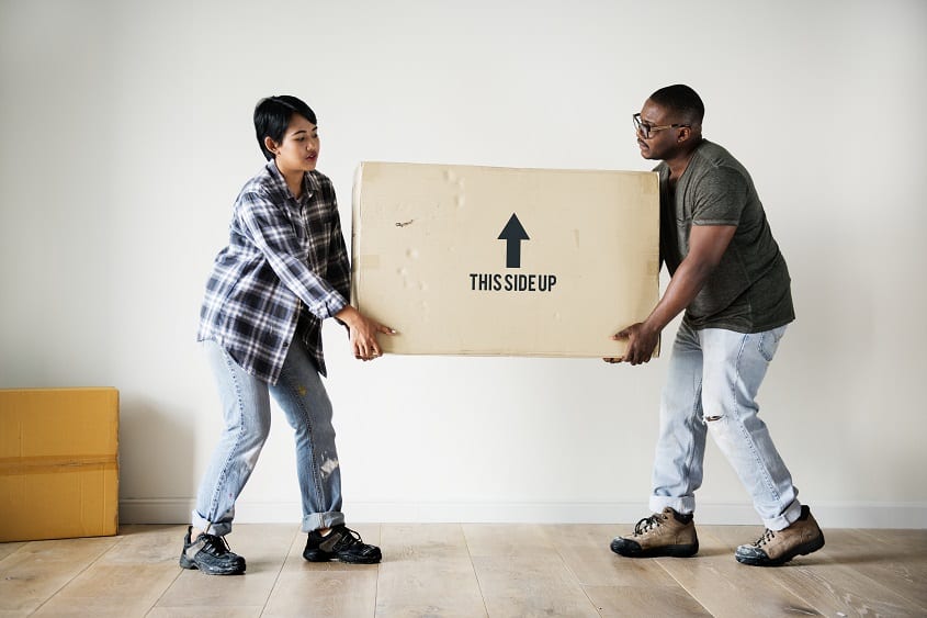 African-Canadian-family-lifting-box-moving-to-new-house