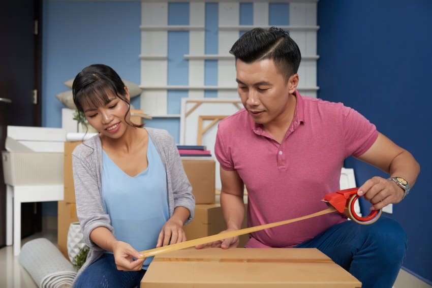 Couple Packing Moving Boxes Properly